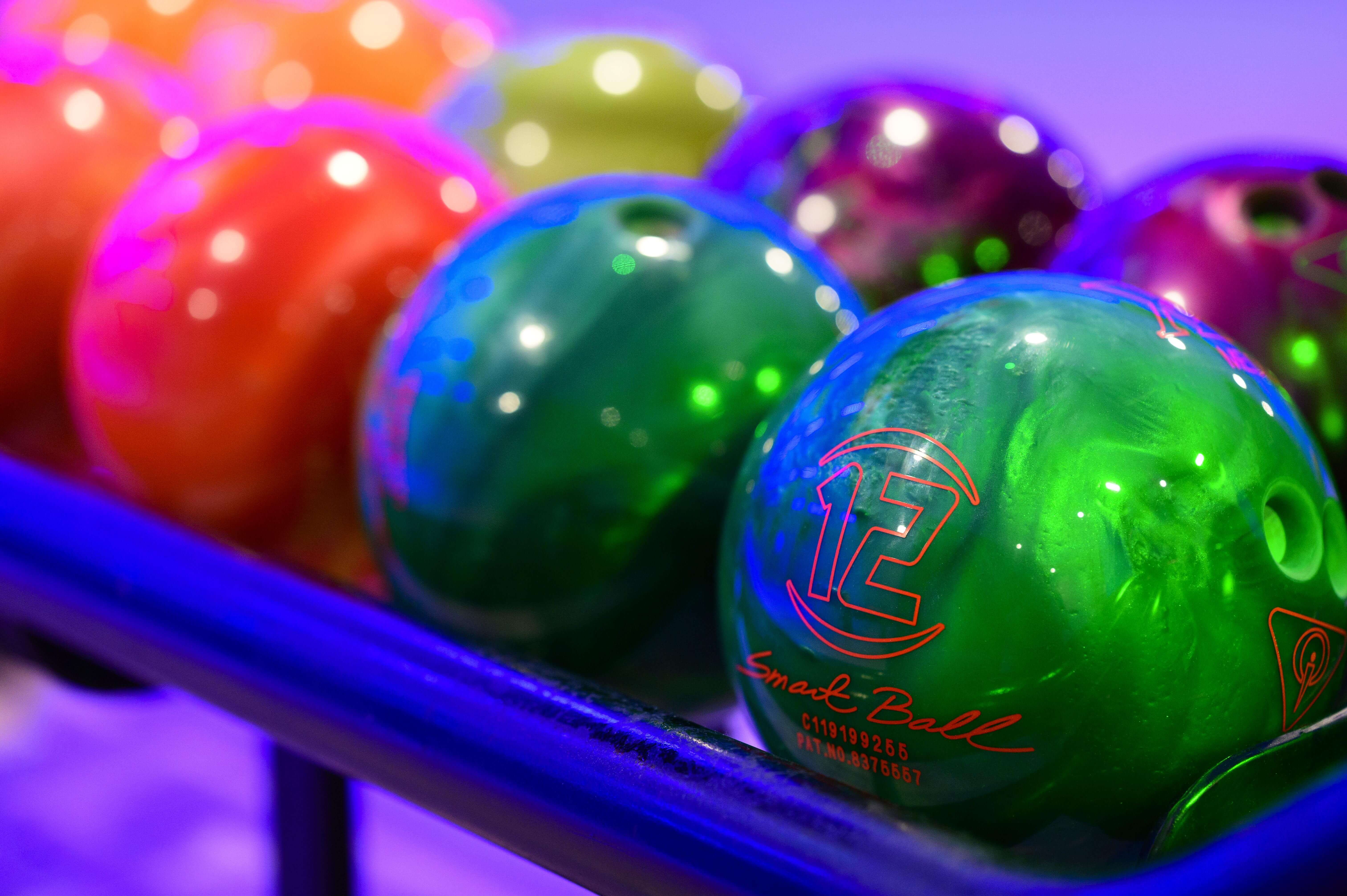 Brightly coloured bowling balls lined up